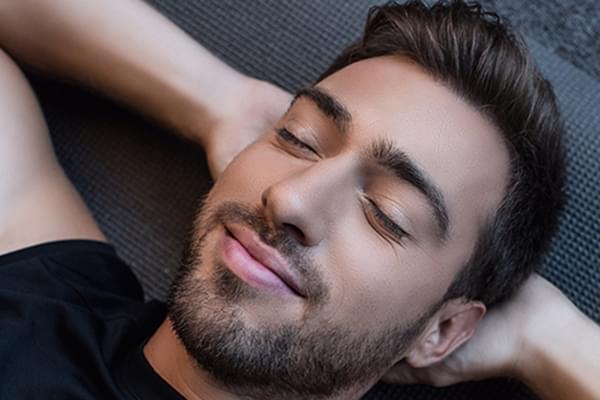 Image of Man Relaxing on Mat
